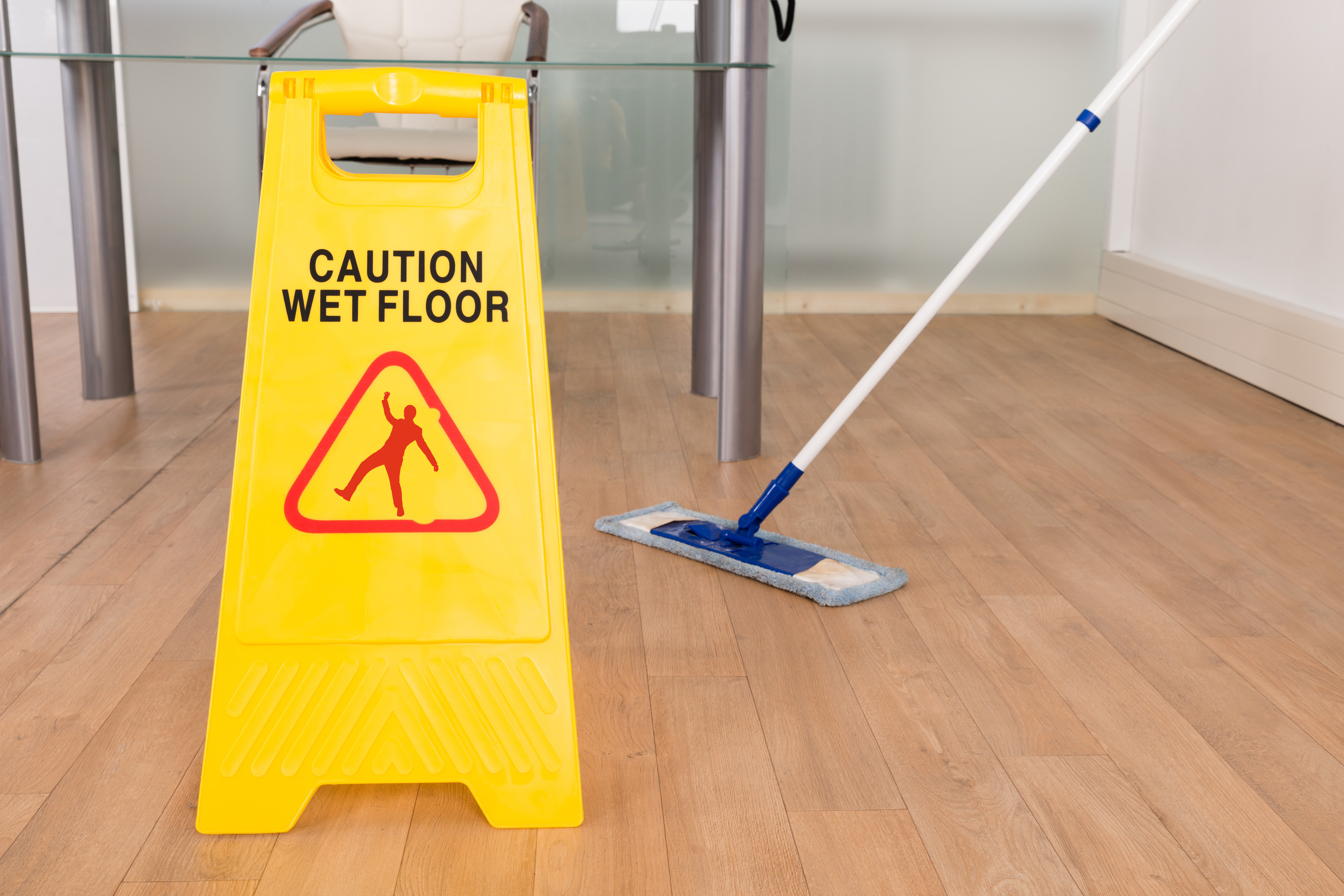 Caution wet floor sign on a wooden floor